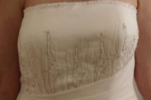 top of dress with pink, green and clear crystal detail
