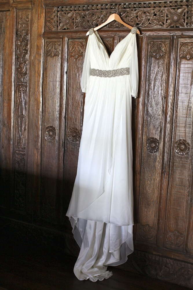 Pronovias 2011 Famosa. Grecian inspired gown featuring draped sleves and accented with a beaded belt and shoulders.