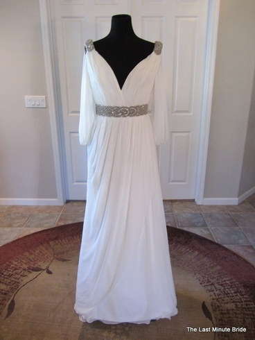 Pronovias 2011 Famosa. Grecian inspired gown featuring draped sleves and accented with a beaded belt and shoulders.