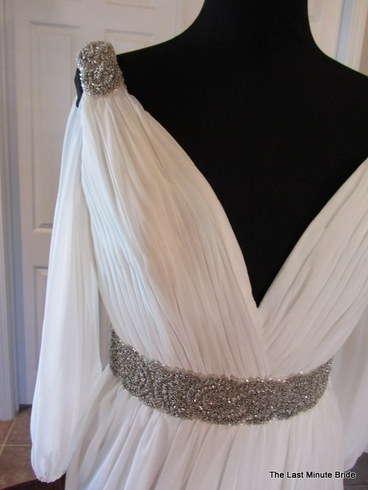 Pronovias 2011 Famosa. Grecian inspired gown featuring draped sleves and accented with a beaded belt and shoulders.
